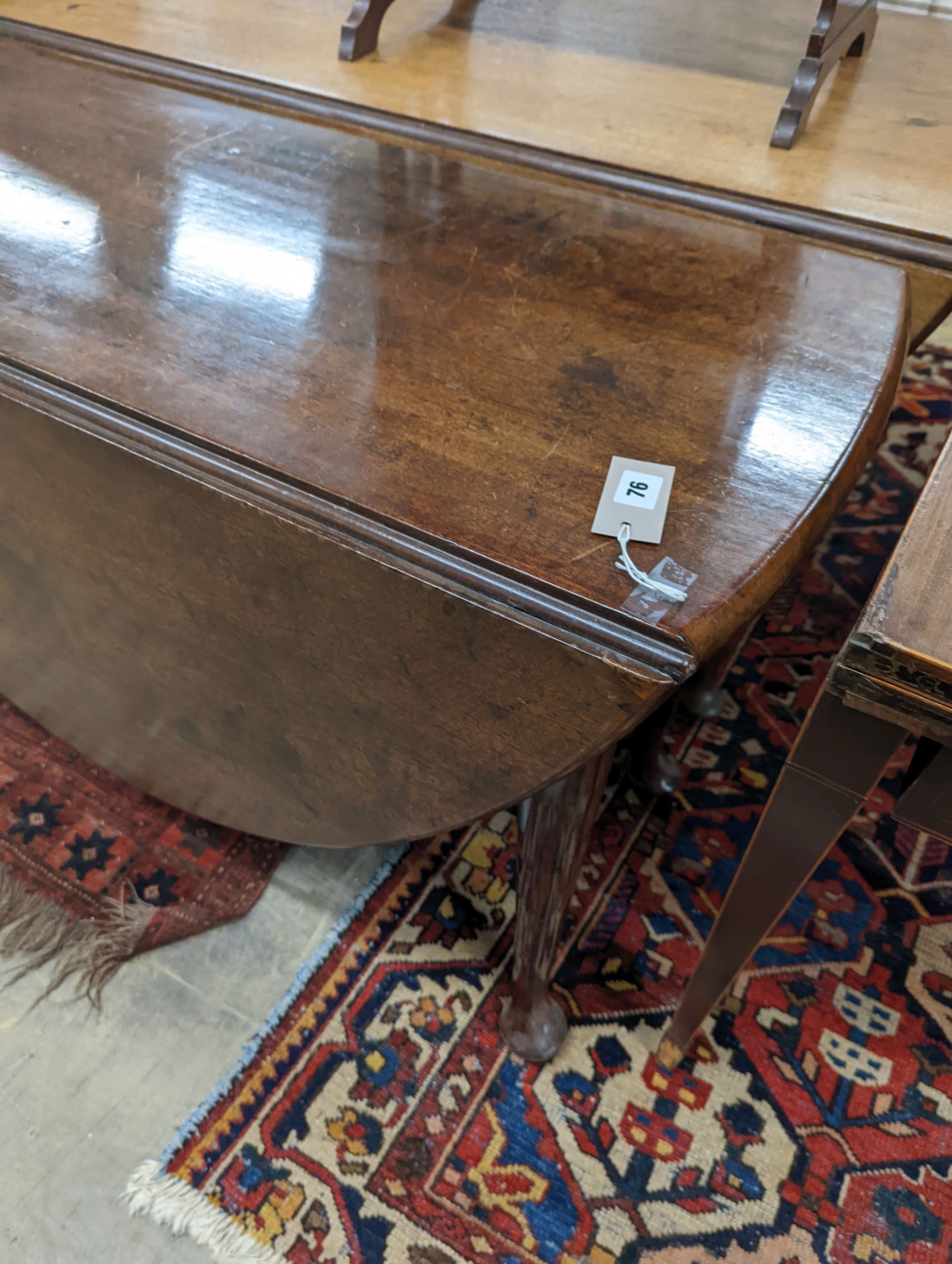 A George III oval mahogany drop leaf pad foot dining table, width 108cm, length 134cm extended, height 70cm
